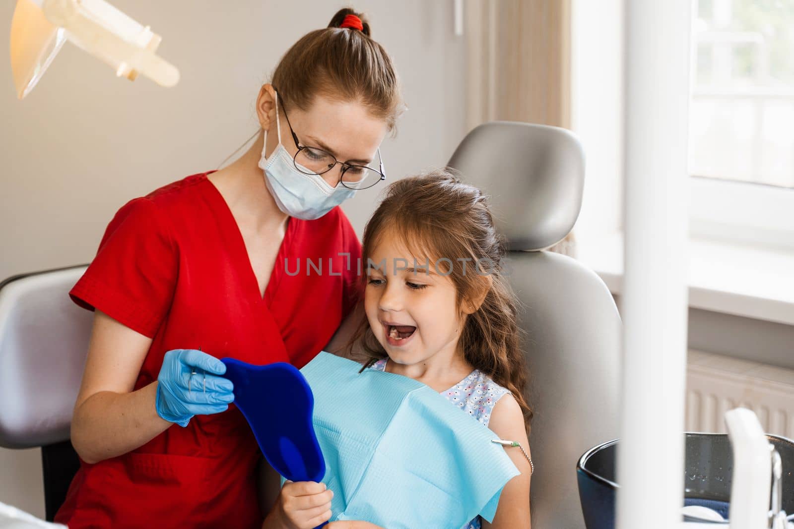 Children dentistry. Dentist and child patient. Consultation with child dentist at dentistry. Teeth treatment. Child looking in the mirror at the dentist. Happy child patient of dentistry