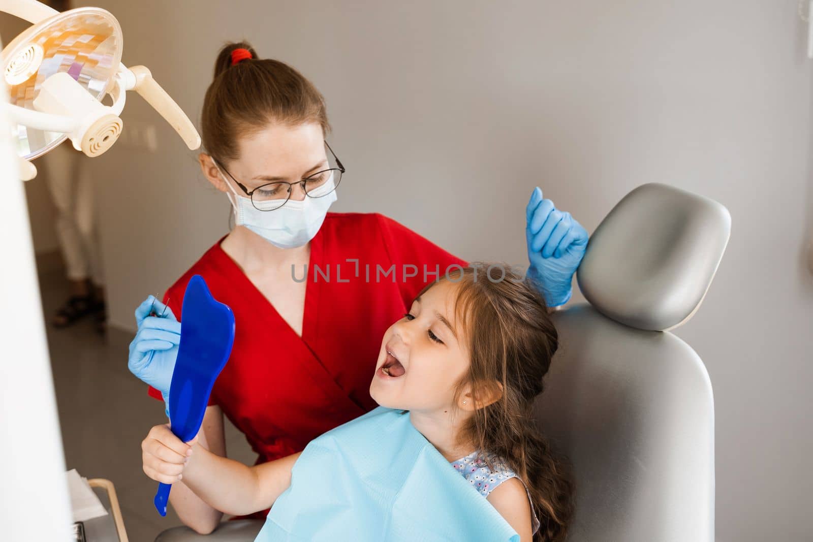 Children dentistry. Dentist and child patient. Consultation with child dentist at dentistry. Teeth treatment. Child looking in the mirror at the dentist. Happy child patient of dentistry