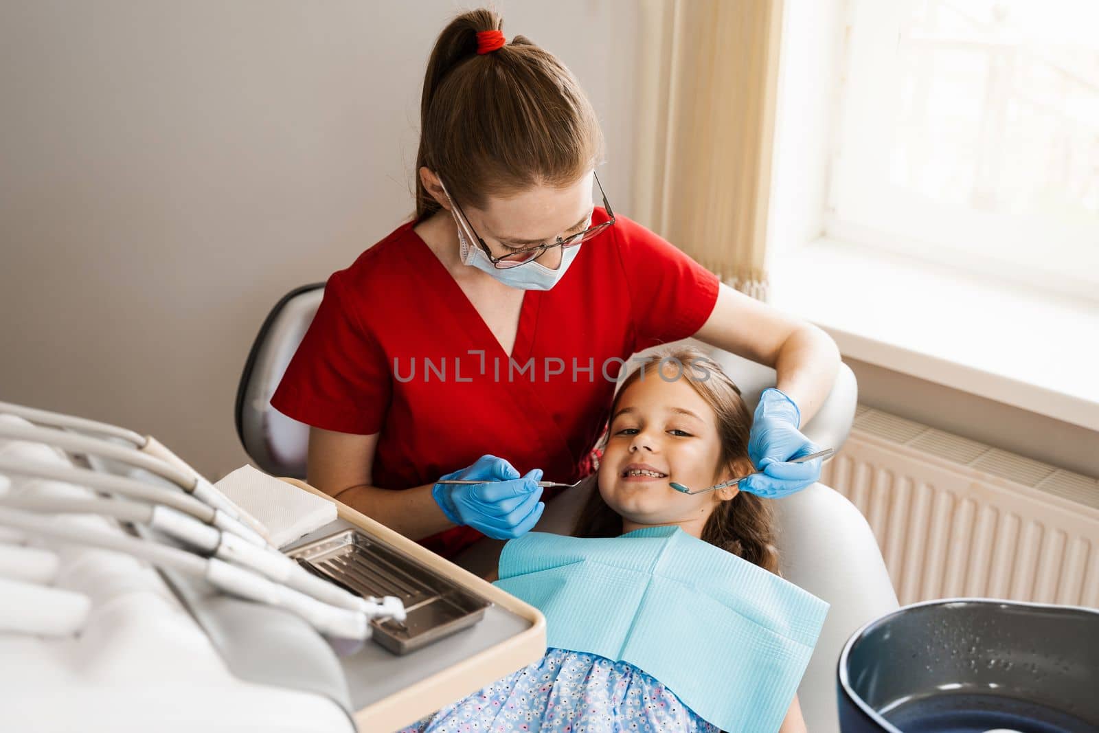 Cheerful child girl smiling at dentists consultation in dentistry. Dental diseases. Consultation with pediatric dentist for treatment of toothache in child