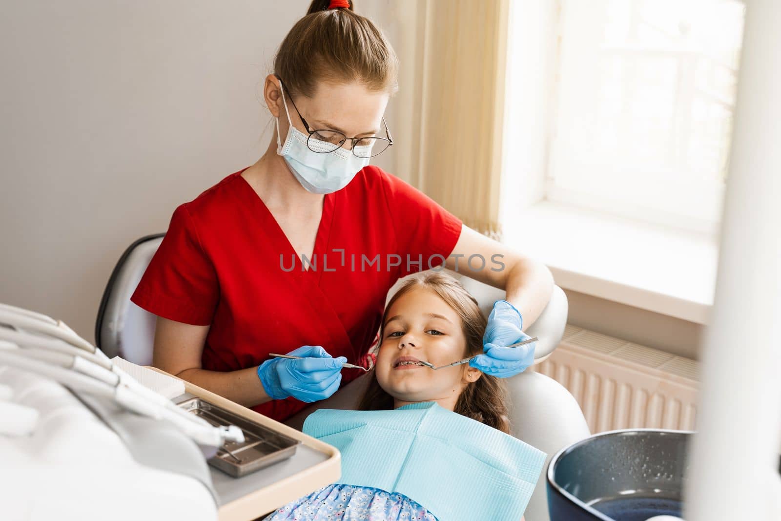 Cheerful child girl smiling at dentists consultation in dentistry. Dental diseases. Consultation with pediatric dentist for treatment of toothache in child