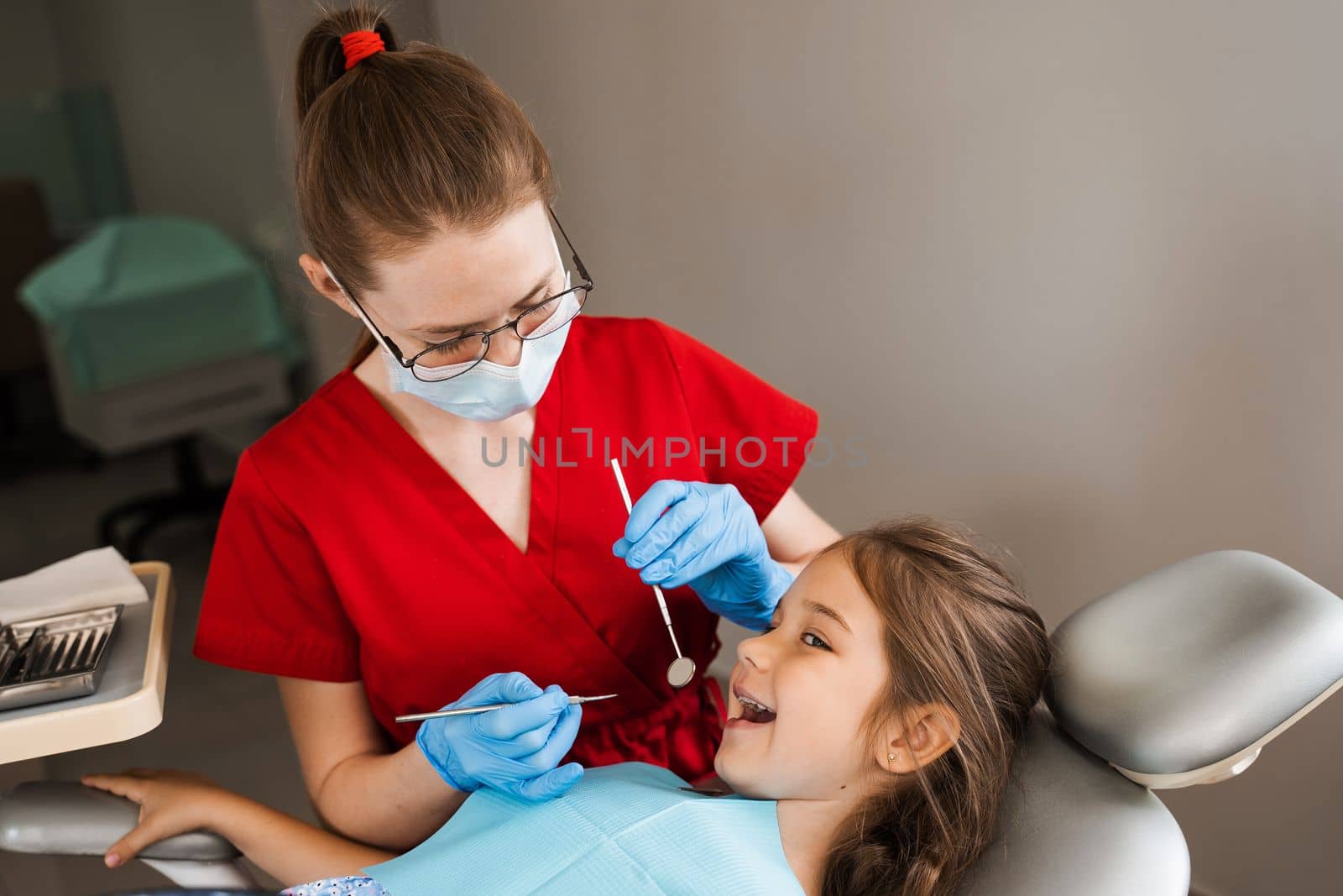 Cheerful child girl smiling at dentists consultation in dentistry. Dental diseases. Consultation with pediatric dentist for treatment of toothache in child