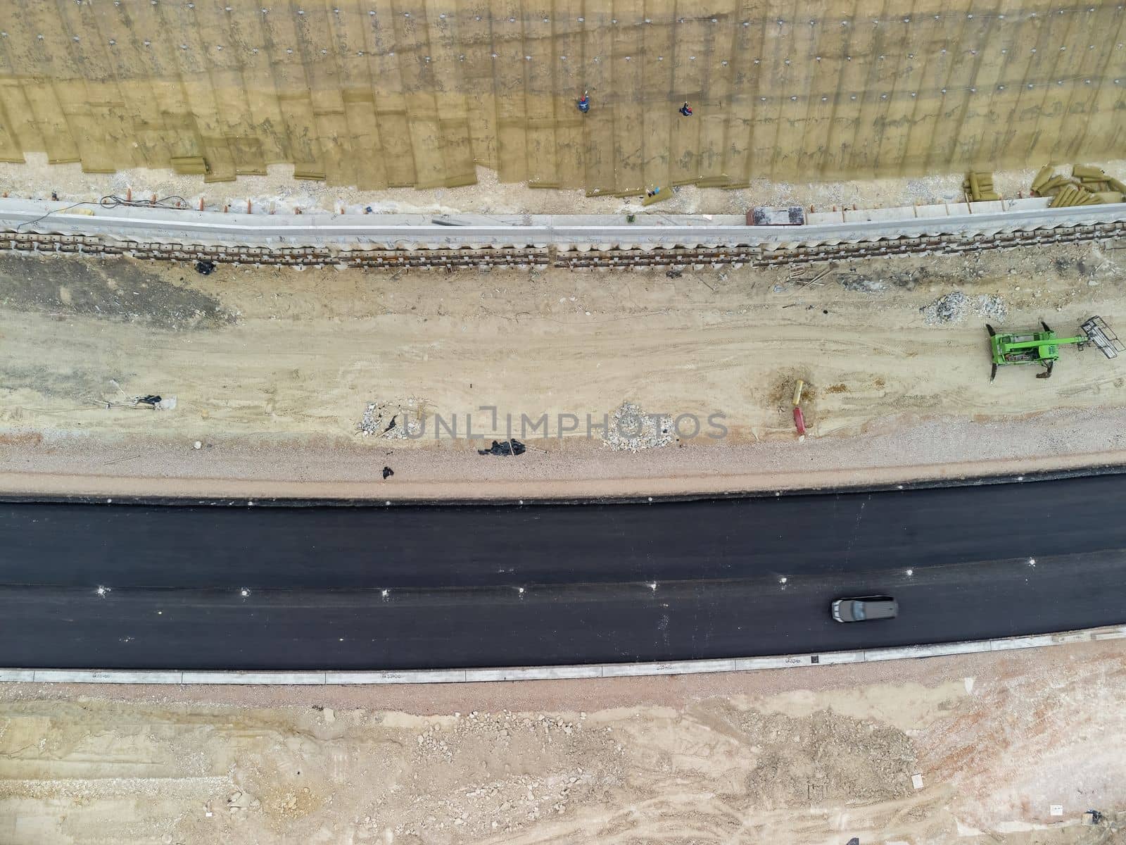 Aerial drone shot Road construction in progress in wild nature canyon.