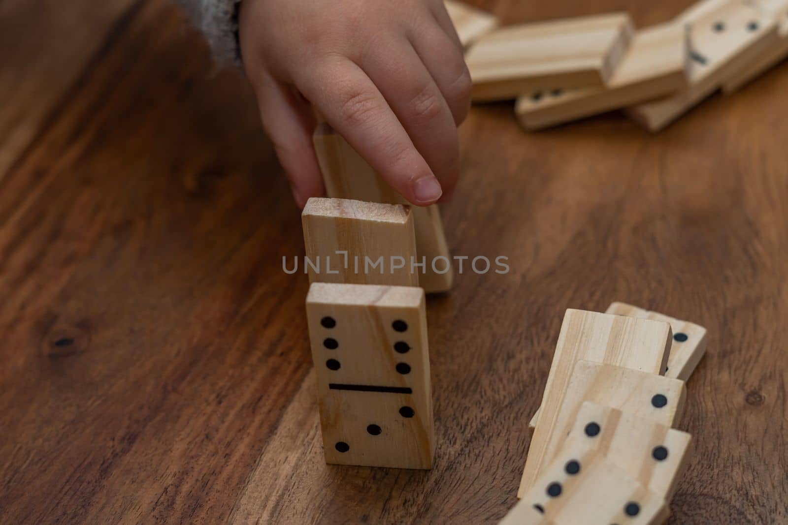 child's hands playing dominoes with blurred focus by joseantona