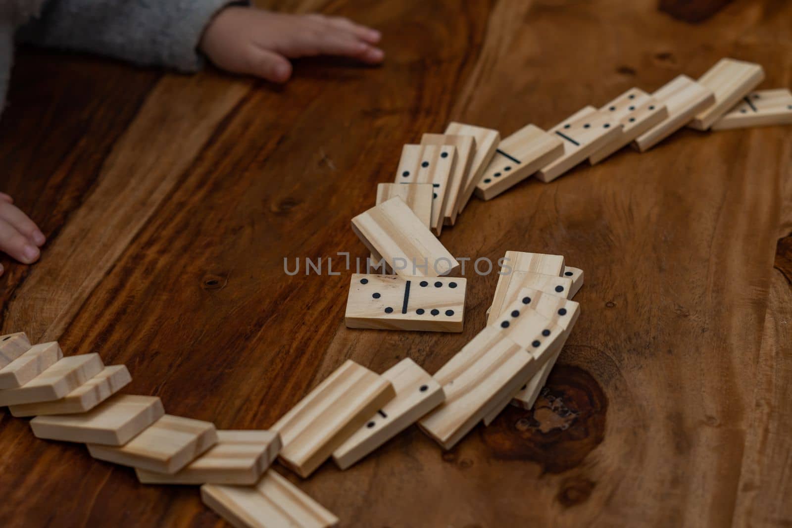 child's hands playing dominoes with blurred focus by joseantona