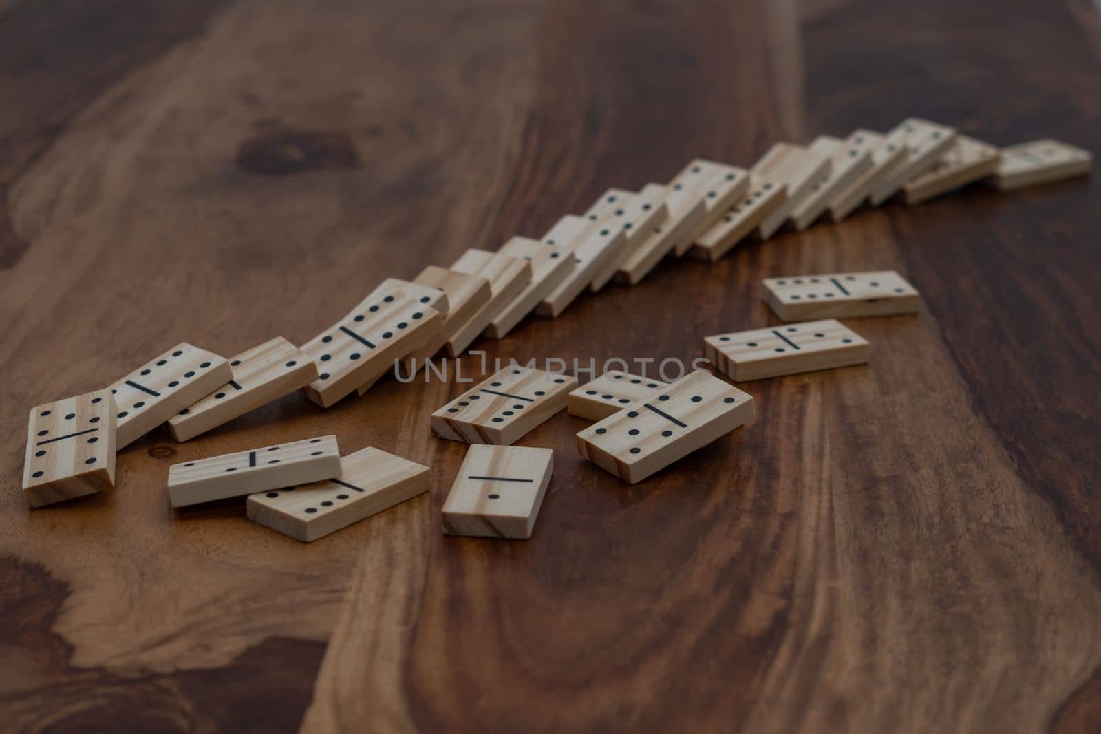 wooden dominoes in a row on a wooden table