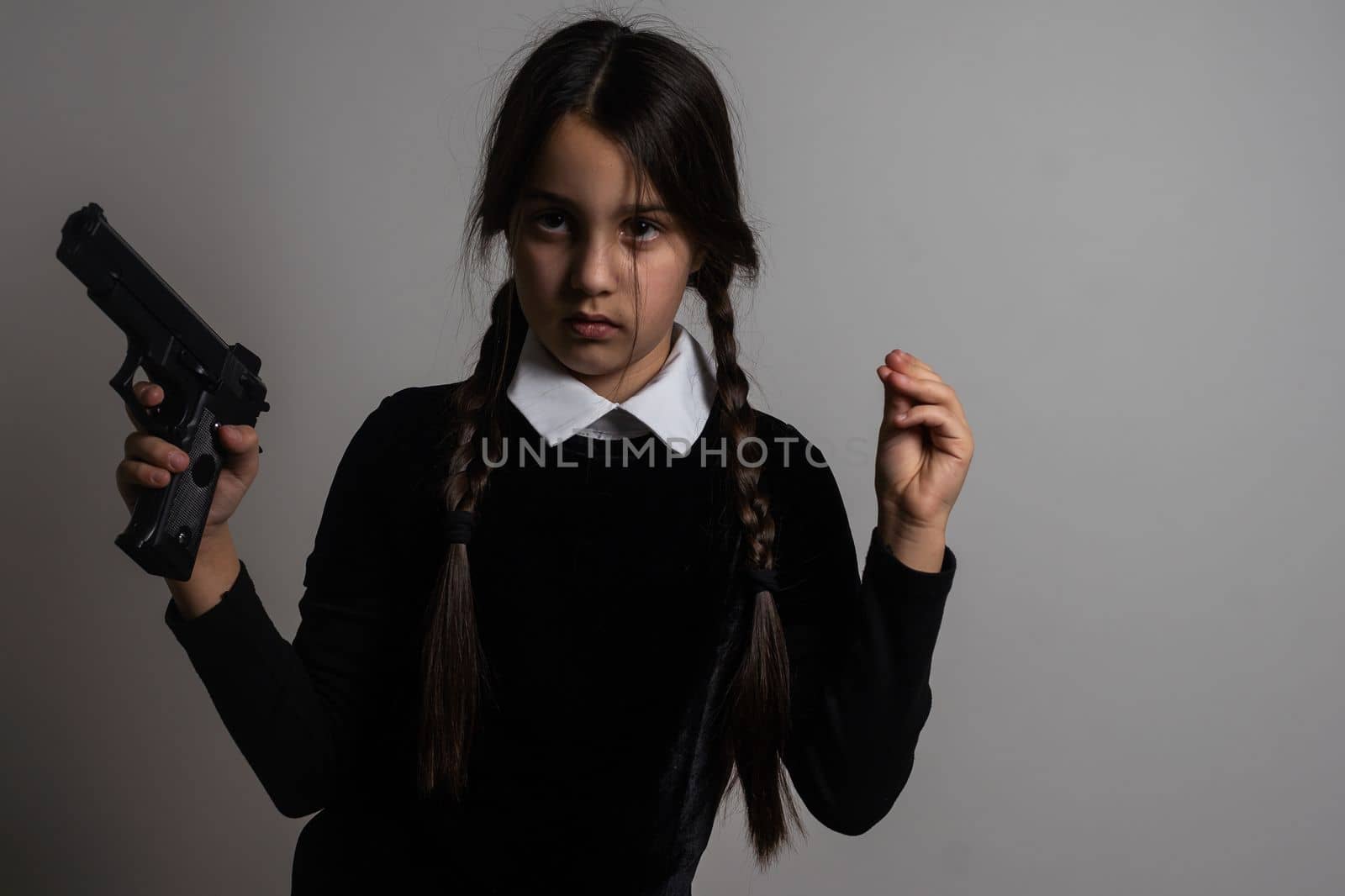 Wednesday Gothic girl with pistol, weapon.