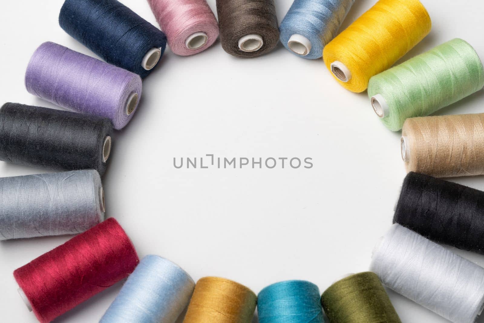 bobbins of sewing thread on white background by joseantona