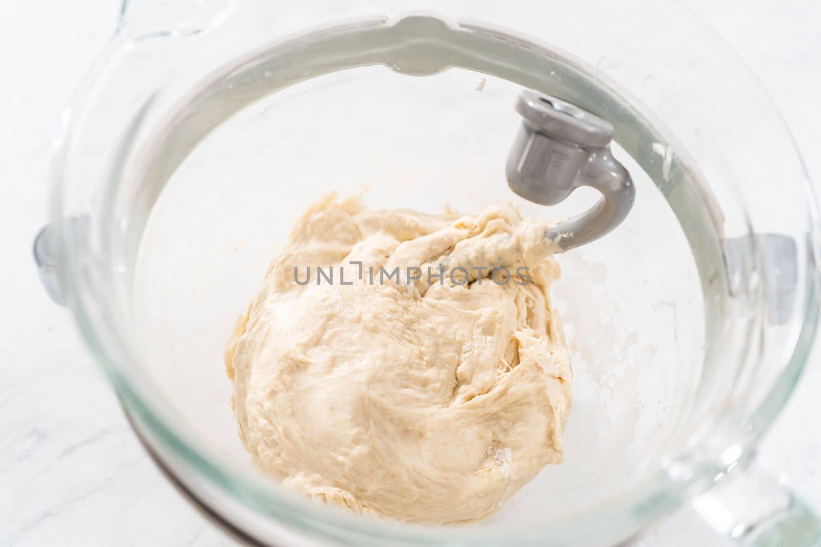 Mixing bread dough in a stand-alone kitchen mixer to bake patriotic cinnamon twists.