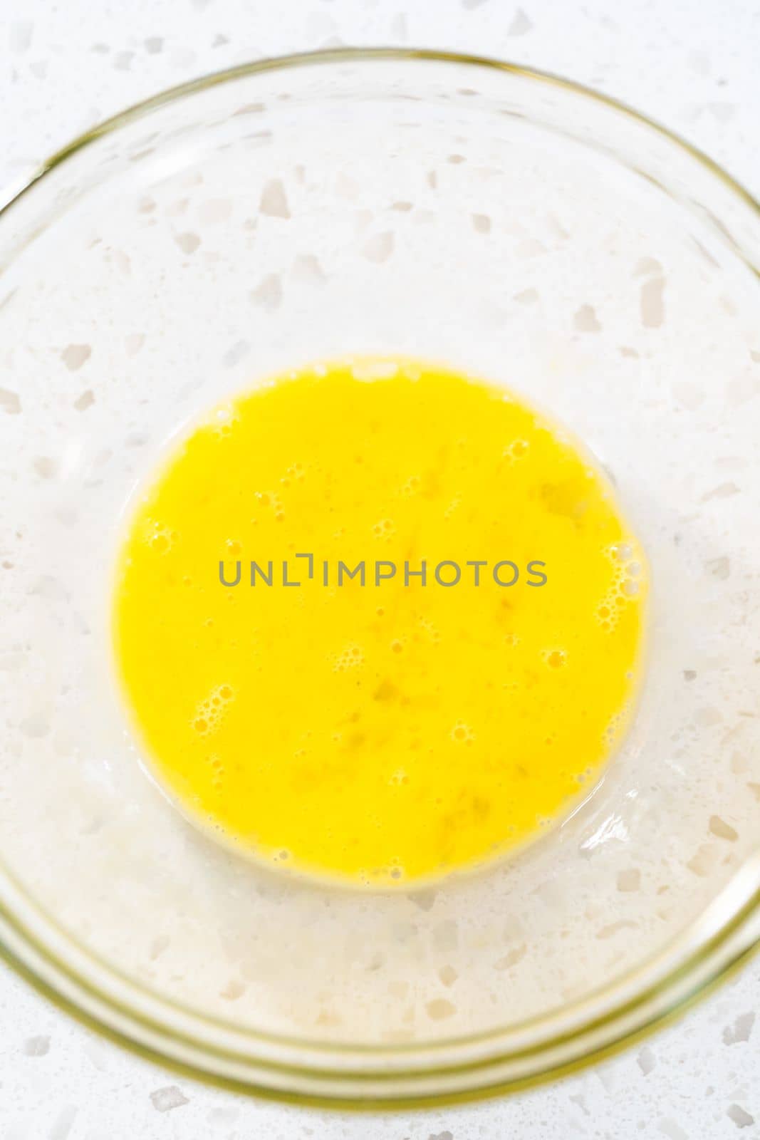 Whisking an egg to make an egg wash for sweet cherry empanadas.