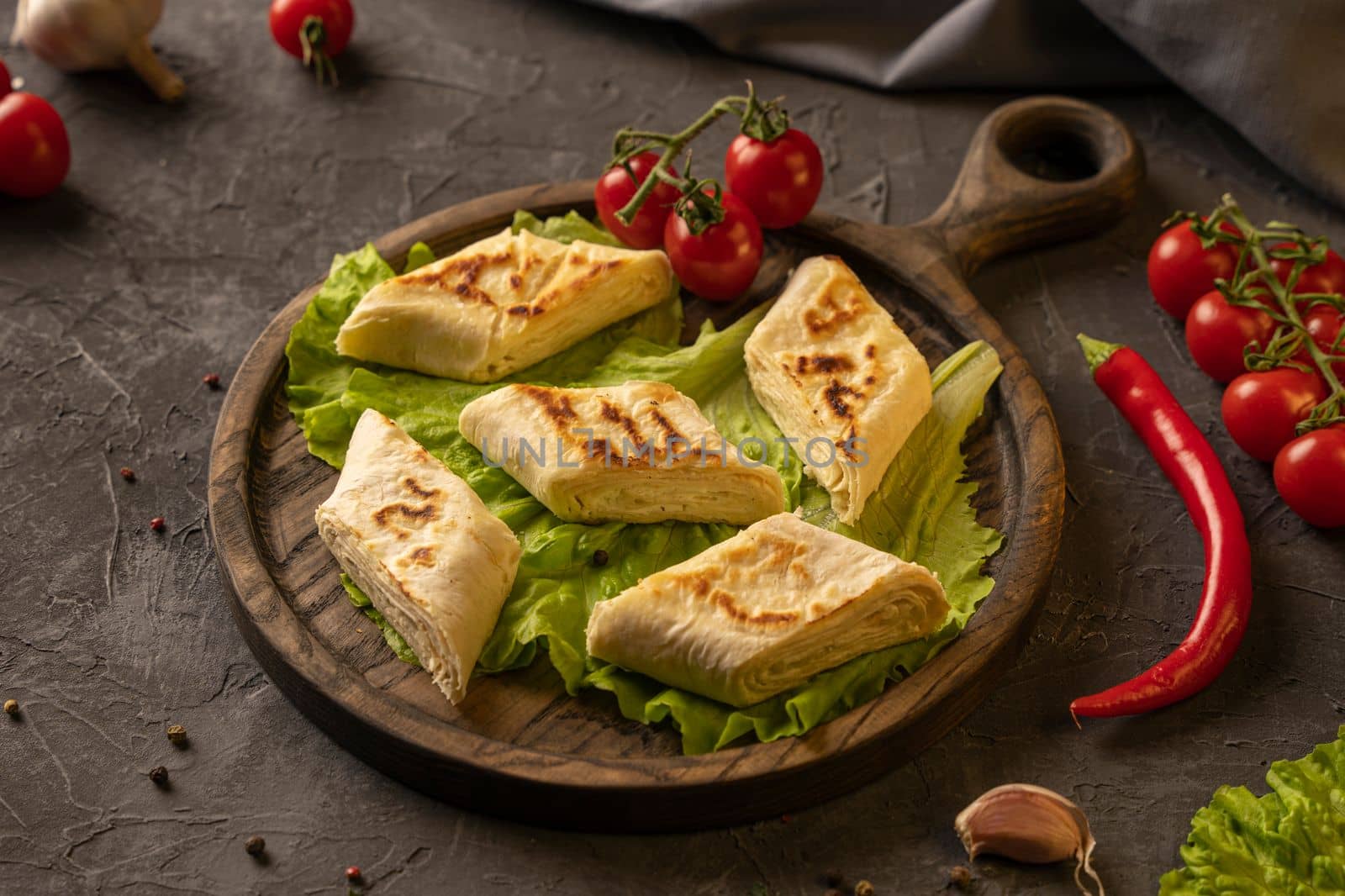 Delicious fried pita bread roll with cottage cheese and herbs. Fried puff rolls of thin Armenian lavash stuffed with cottage cheese. Wrapped tortillas. Traditional cuisine. Delicious and healthy food.