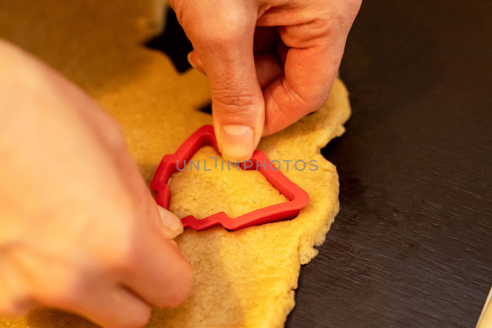 Dough, cookie cutters, mold. Dough for preparing cookies. molds on table. hands making cookies. cutting the dough with the molding trim.