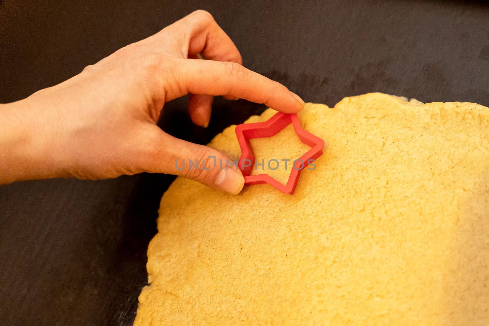 Dough, cookie cutters, mold. Dough for preparing cookies. molds on table. hands making cookies. cutting the dough with the molding trim.