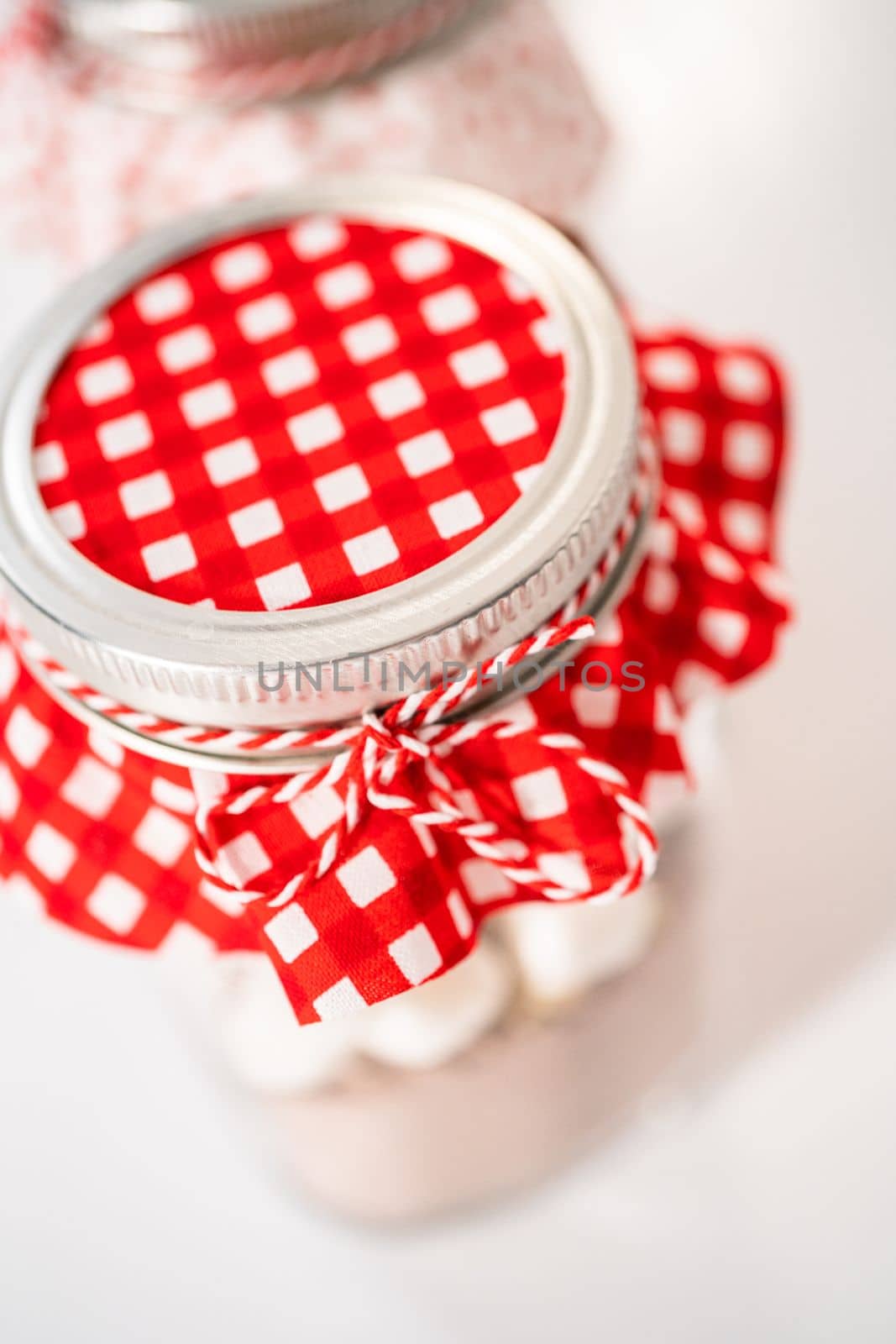 Making homemade hot chocolate mix in drinking mason jar for Christmas food gift.