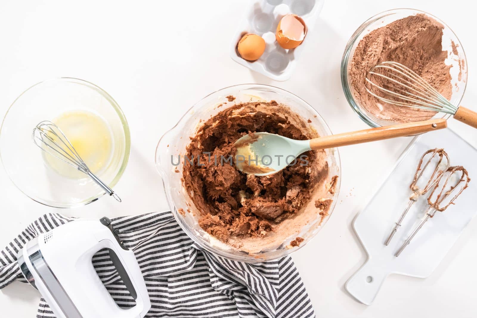 Flat lay. Mixing ingredients in a glass mixing bowl to bake chocolate cookies.