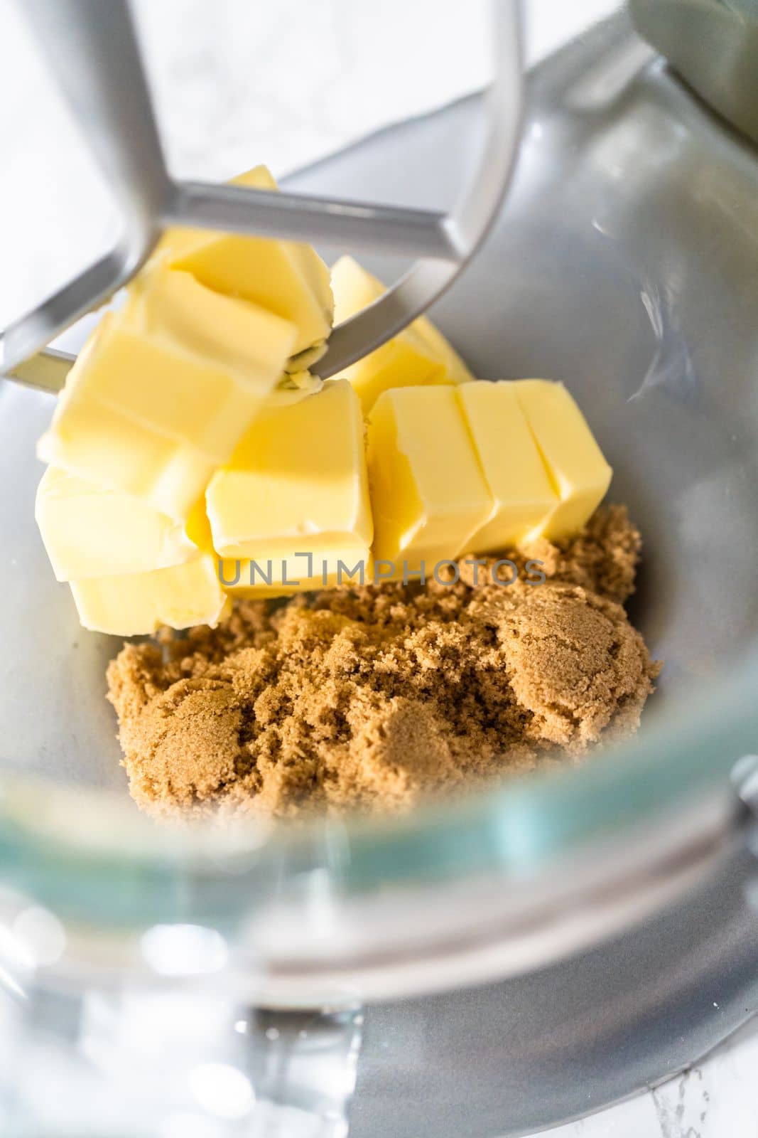 Mixing ingredients in kitchen mixer to bake mini Easter bread kulich.