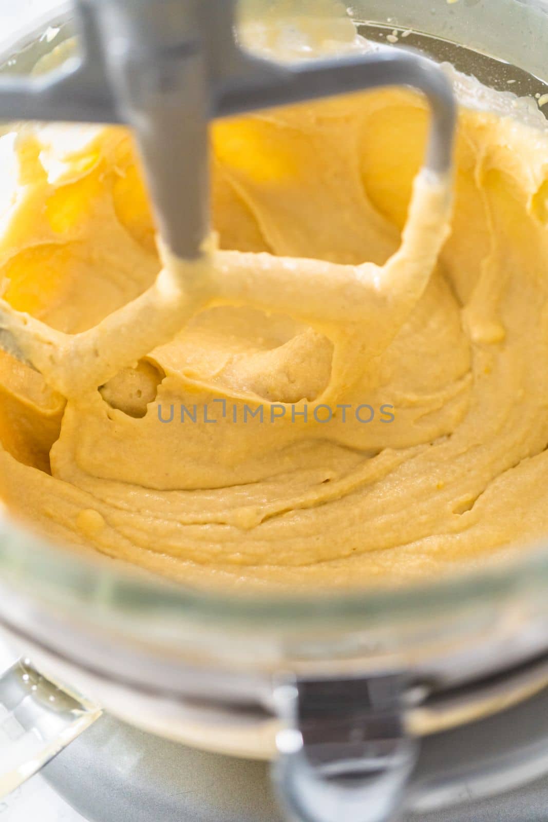 Mixing ingredients in kitchen mixer to bake mini Easter bread kulich.