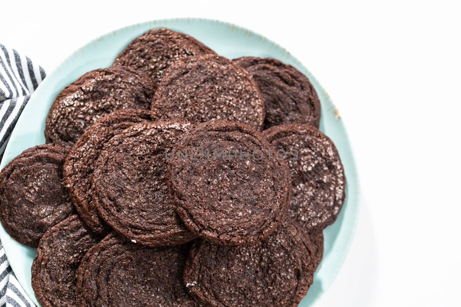 Freshly baked chocolate cookies on a blue plate.