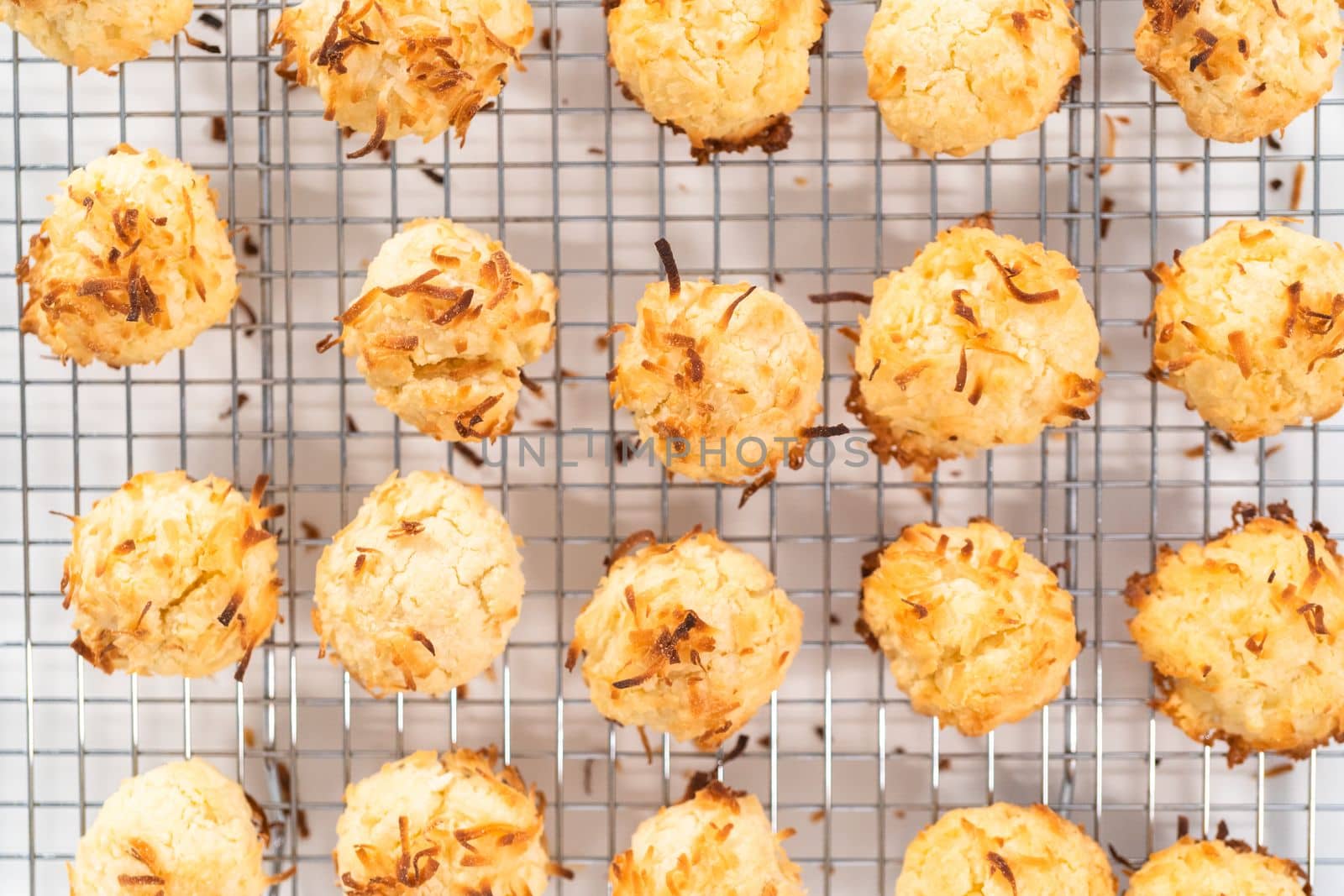Cooling freshly baked coconut cookies on the kitchen drying rack.