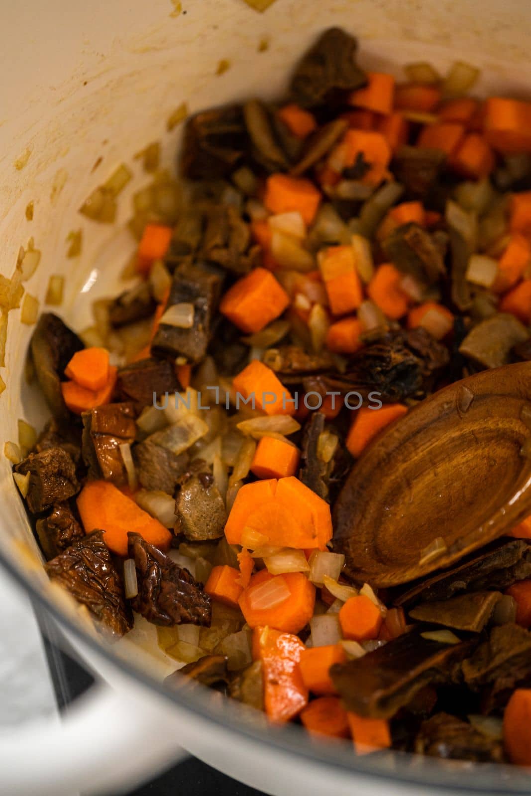 Cooking creamy wild mushroom soup made in an enameled dutch oven.