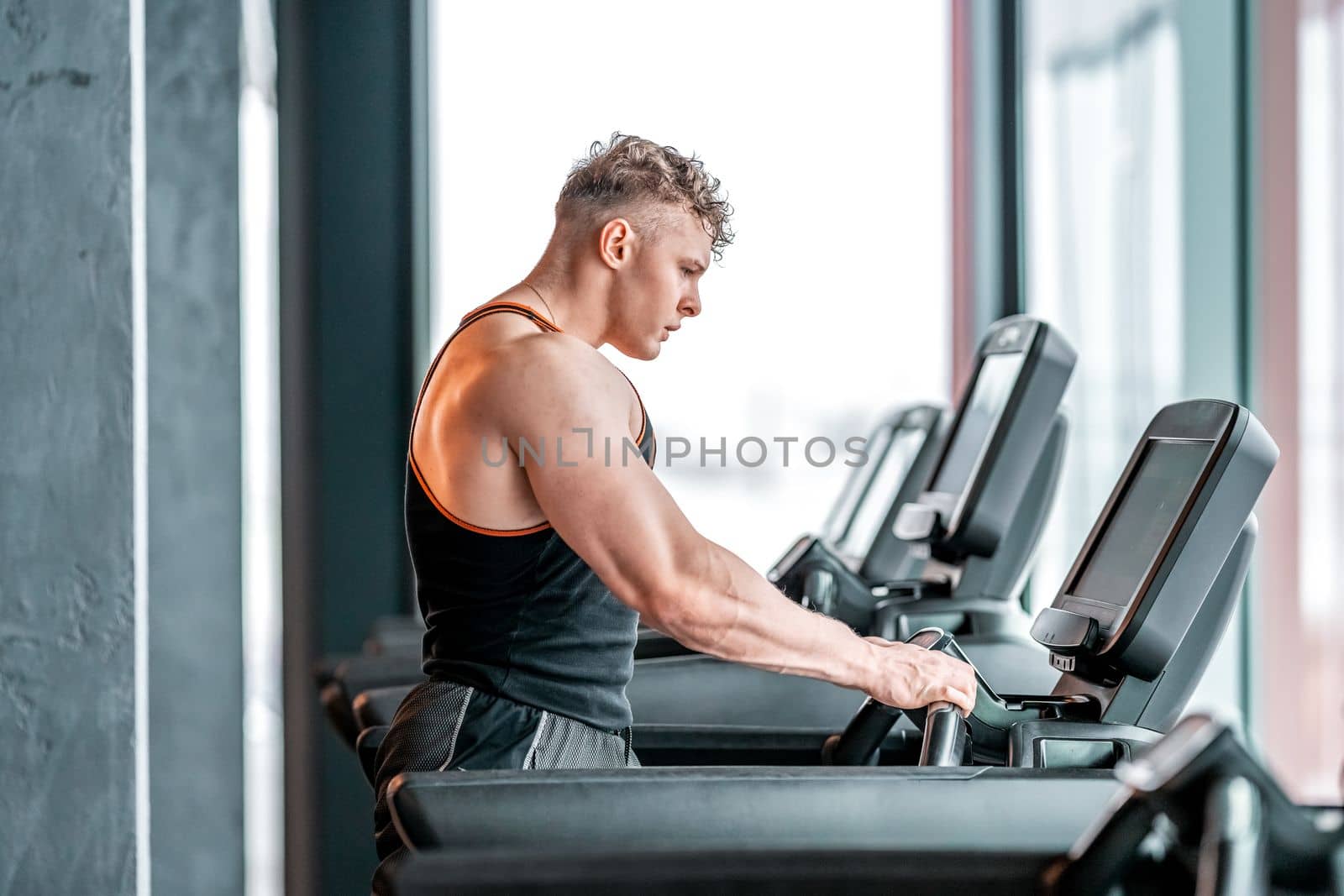 athlete on a treadmill in the gym. High quality photo