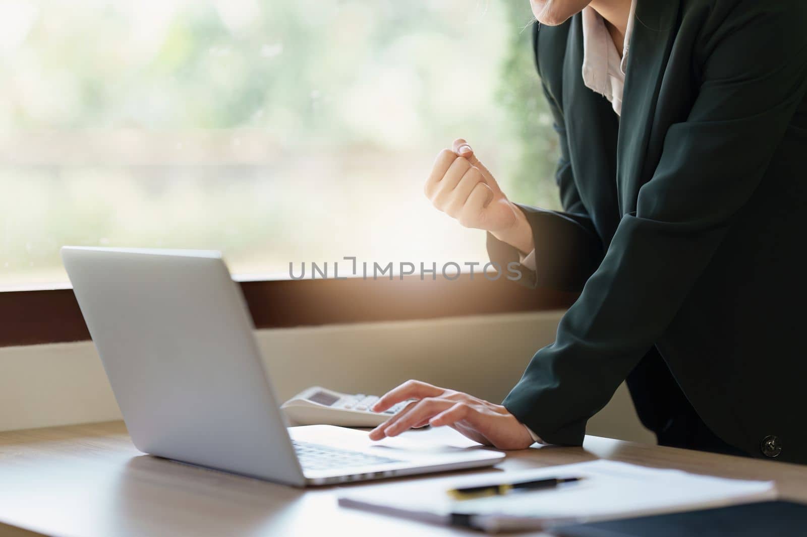 Close up of Happy asian business woman with laptop computer in office. Woman in suit at office.