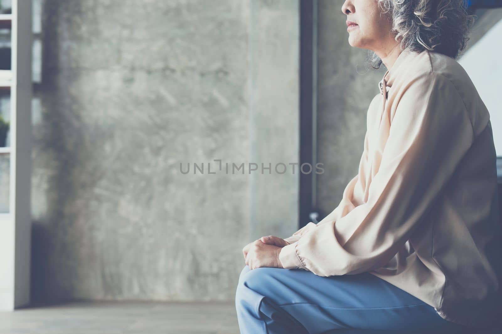 Senior woman feeling blue worried about health problems.