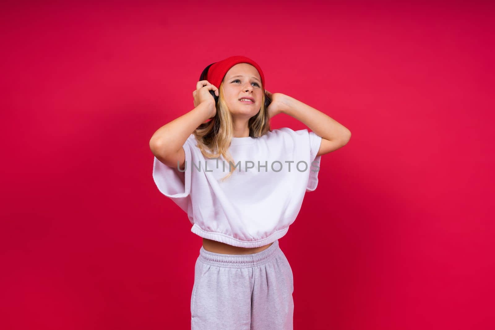 Child music concept. Teenager girl dance in rhythm of melody, listens song in headphones
