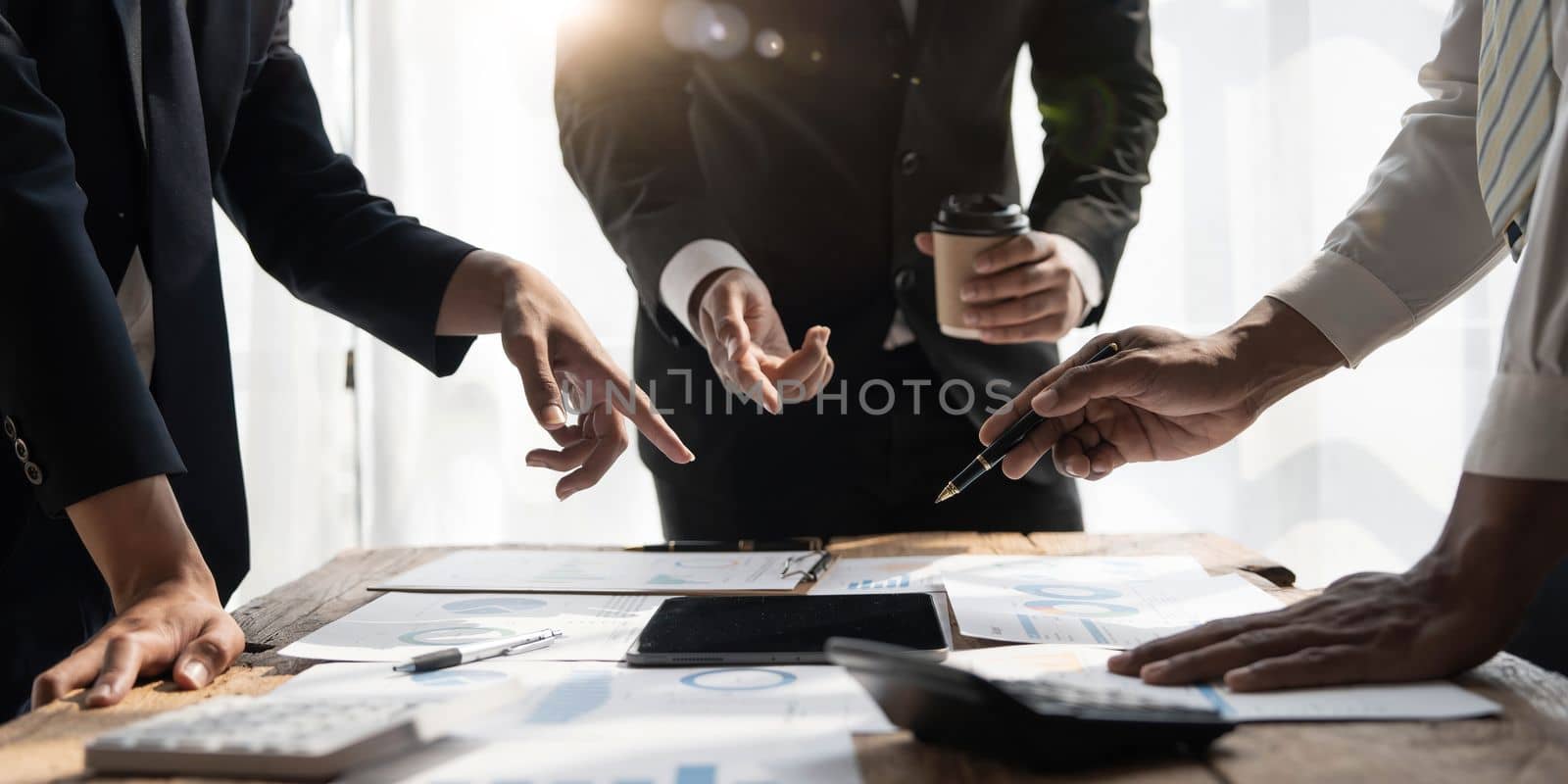 Business People Meeting using laptop computer,calculator,notebook,stock market chart paper for analysis Plans to improve quality next month.