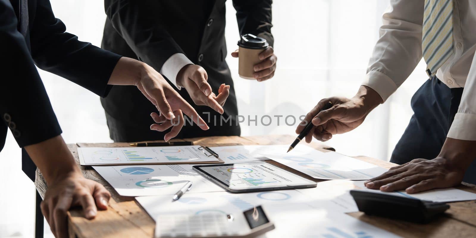 Business People Meeting using laptop computer,calculator,notebook,stock market chart paper for analysis Plans to improve quality next month. Conference Discussion Corporate Concept by wichayada