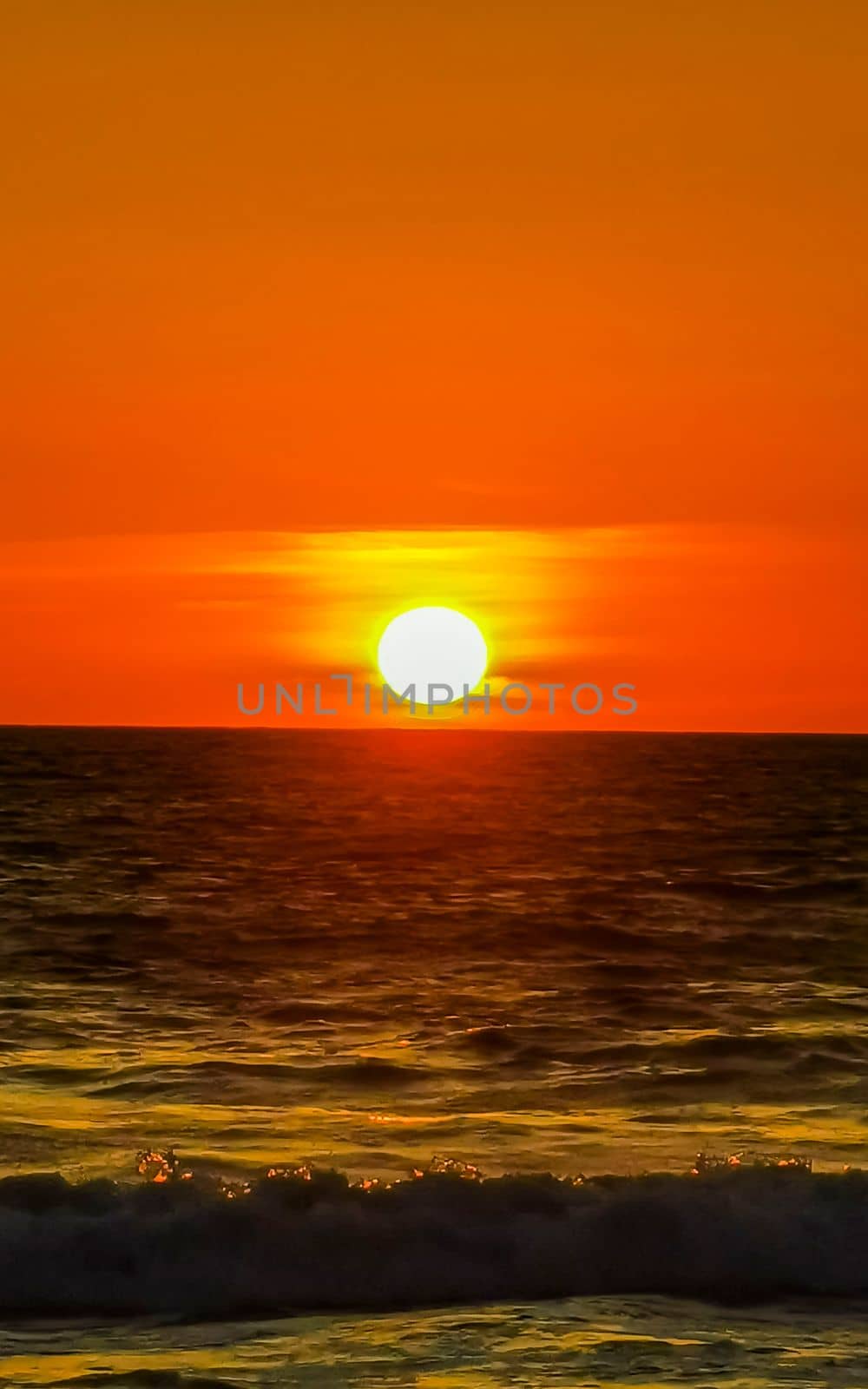 Colorful golden sunset big wave and beach Puerto Escondido Mexico. by Arkadij