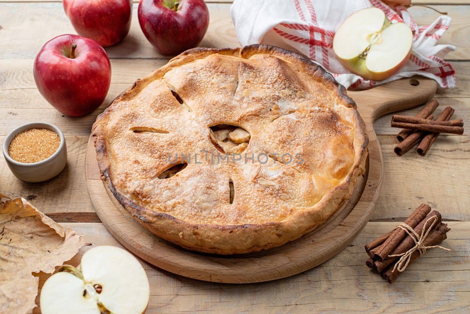 Autumn food. Homemade apple pie with fresh red apples on wooden table