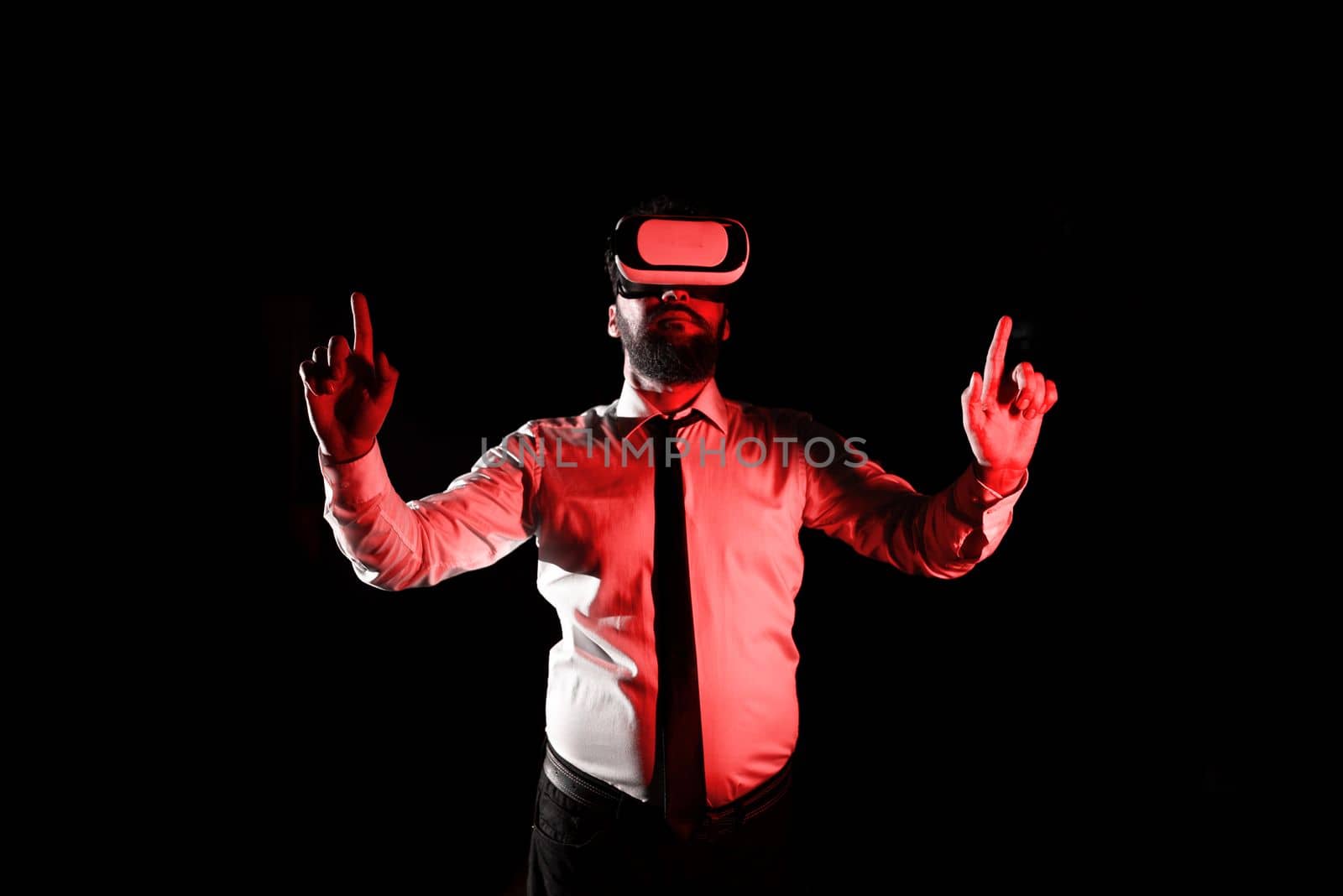 Man Wearing Vr Glasses And Pointing On Important Messages With two Fingers. Businessman Having Virtual Reality Eyeglasses And Showing Crutial Informations. by nialowwa