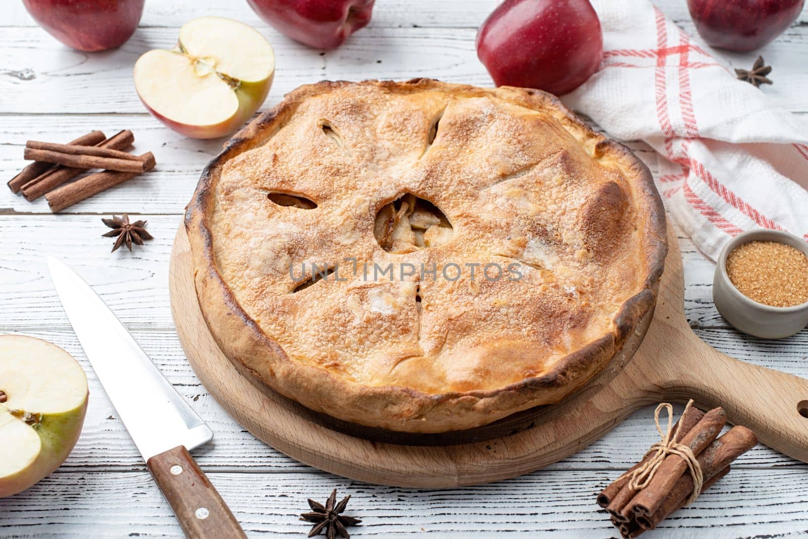 Autumn food. Homemade apple pie with fresh red apples on wooden table