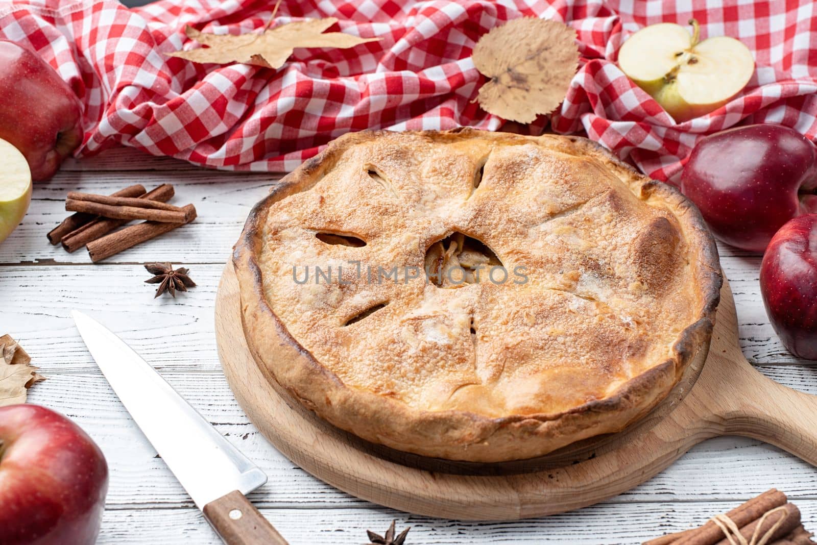 Autumn food. Homemade apple pie with fresh red apples on wooden table