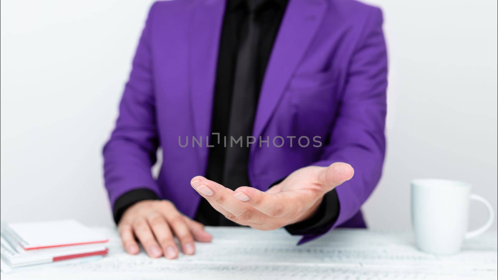 Businessman in Purple jacket Holding Important Message In One Hand. Man In Suit Showing New Crutial Idea In Palm. Executive Presenting Updated Critical Information. by nialowwa