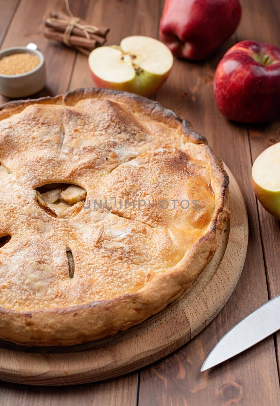 Autumn food. Homemade apple pie with fresh red apples on wooden table