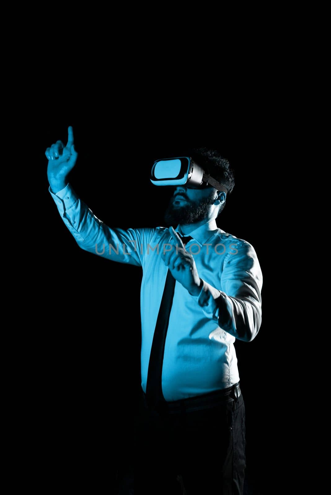 Man Wearing Vr Glasses And Pointing On Important Messages With two Fingers. Businessman Having Virtual Reality Eyeglasses And Showing Crutial Informations. by nialowwa