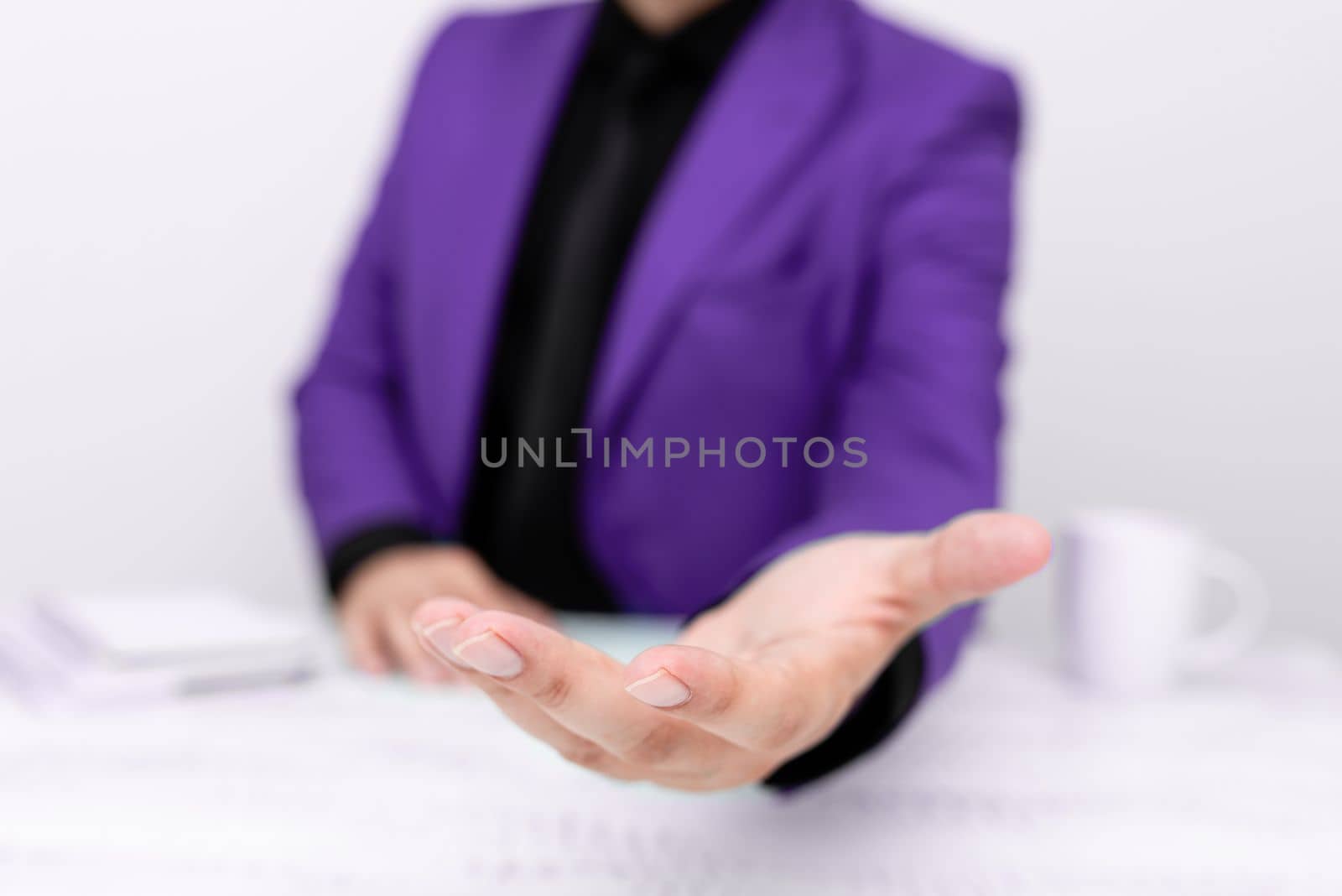 Businessman in Purple jacket Holding Important Message In One Hand. Man In Suit Showing New Crutial Idea In Palm. Executive Presenting Updated Critical Information. by nialowwa