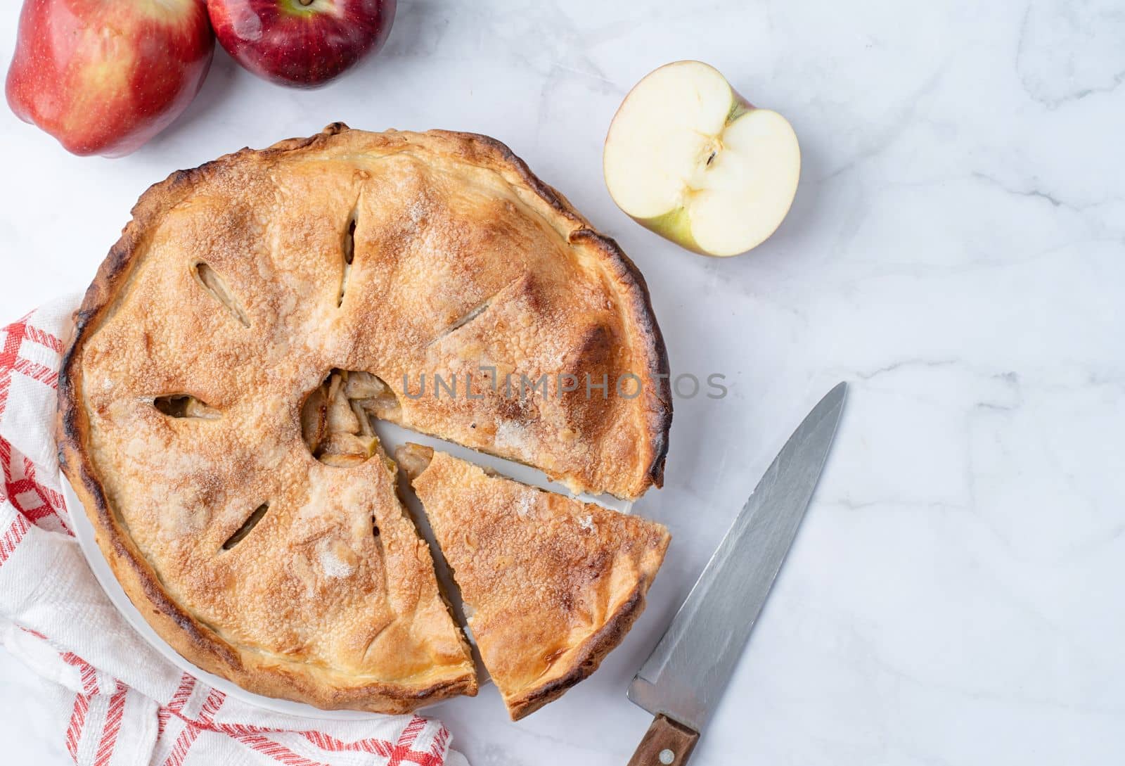 Autumn food. Homemade apple pie with slice with fresh red apples on wooden table