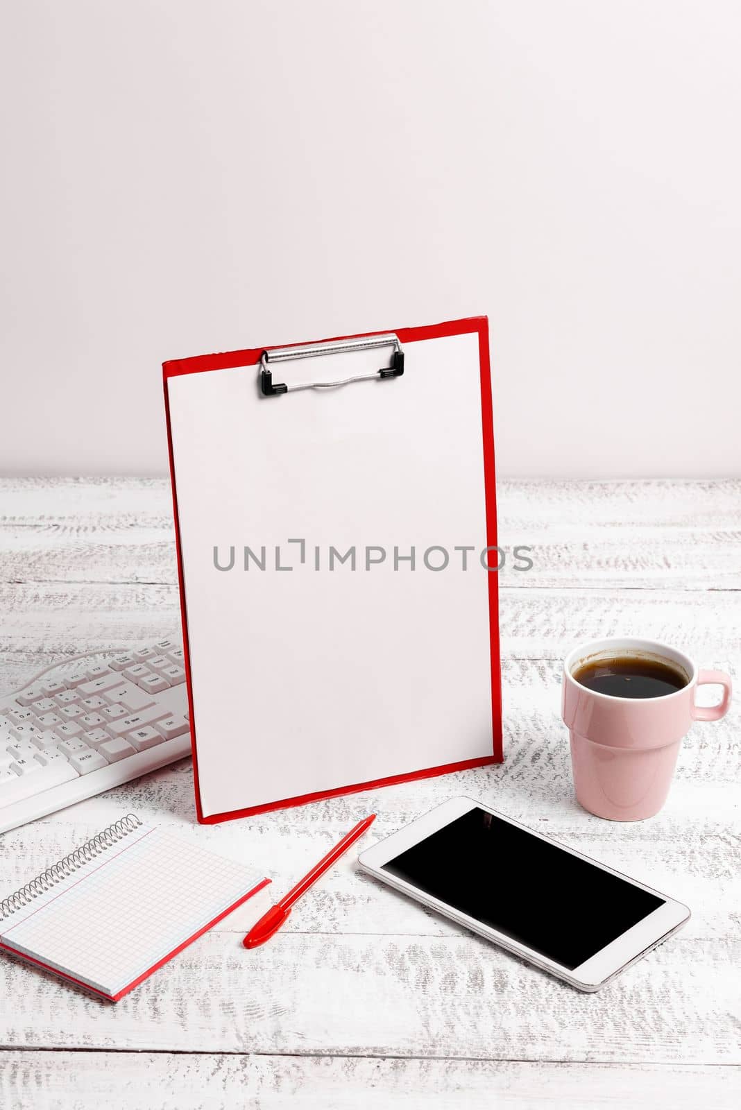 Notebook With Important Messages On Desk With Coffee, Phone And Pen.