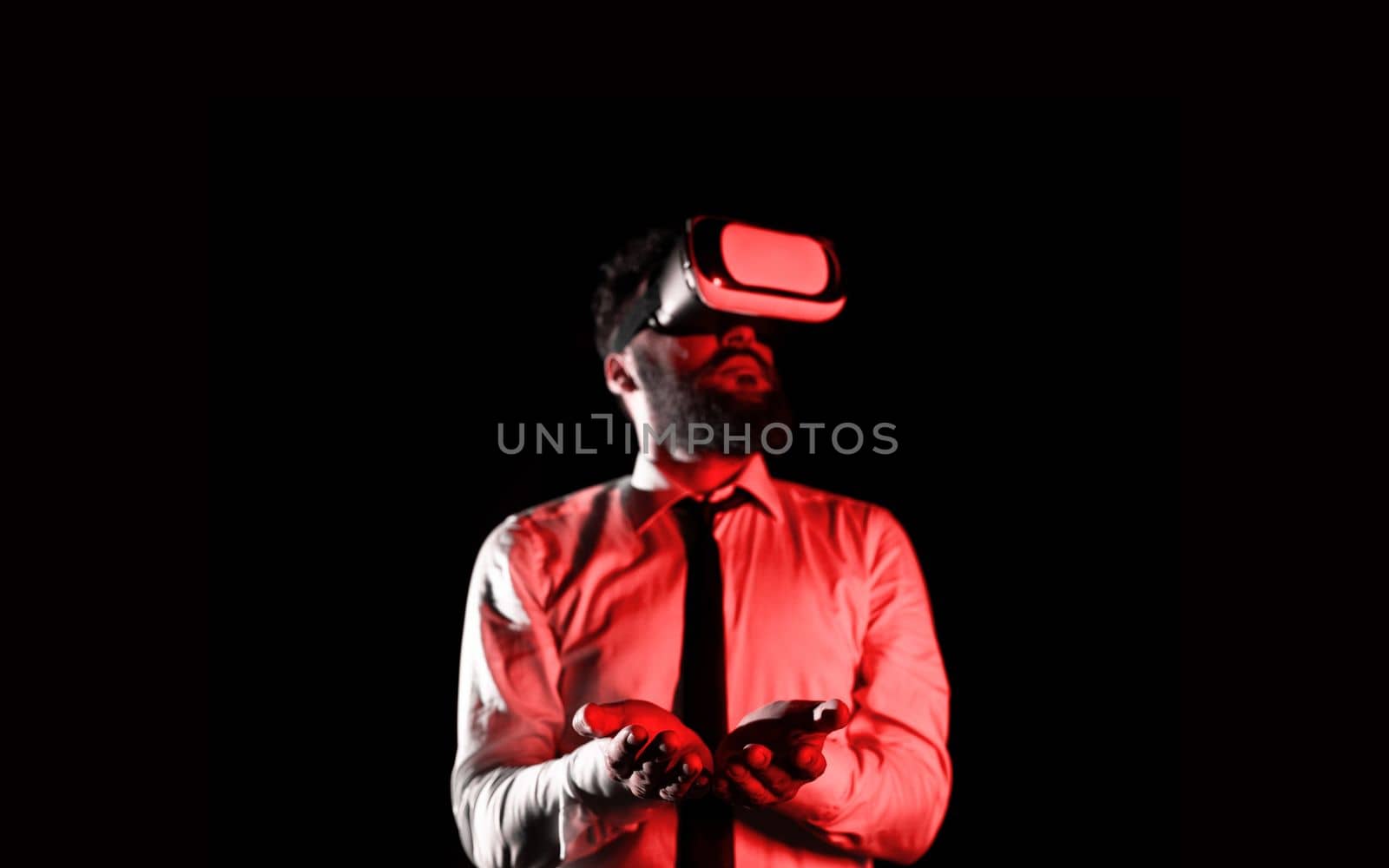 Man Wearing Vr Glasses And Holding Important Messages In Hands. Businessman Having Virtual Reality Eyeglasses And Showing Crutial Informations. by nialowwa