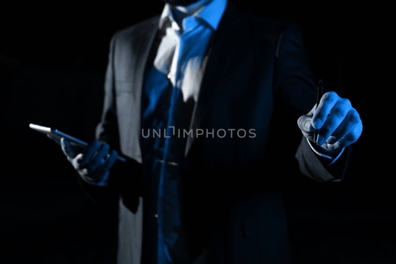 Man Holding Mobile Phone and Pointing On Recent Updates With Pen. Businessman Having Virtual Reality Eyeglasses, Cellphone And Presenting New Idea. by nialowwa