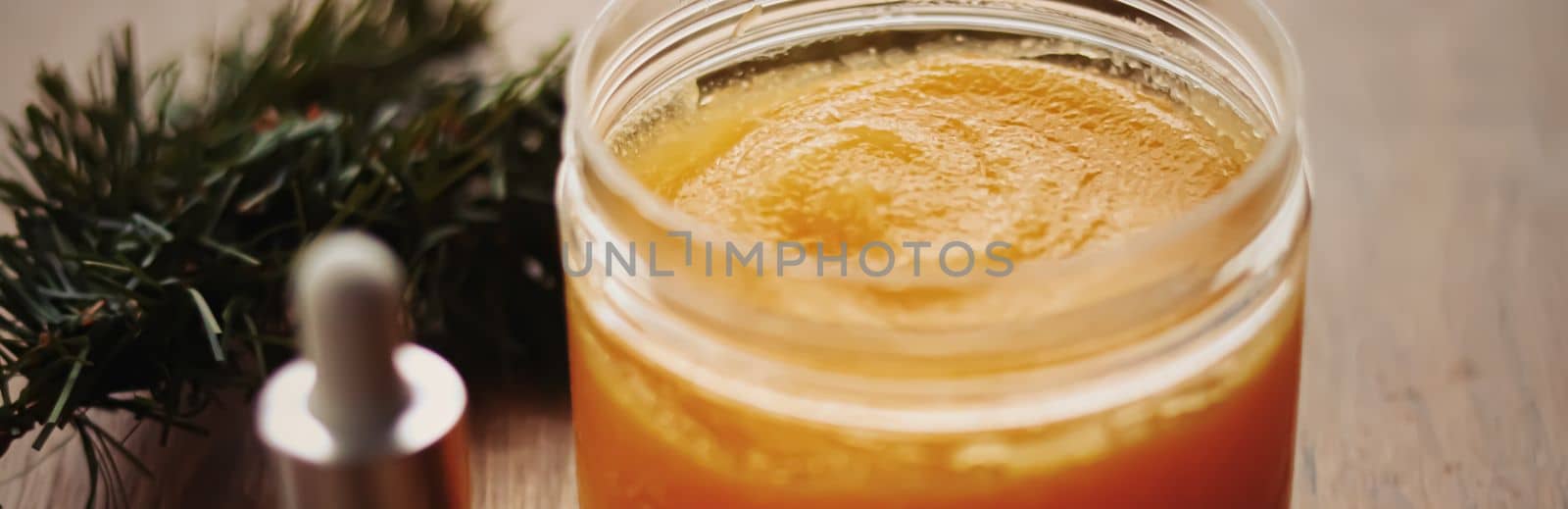 Citrus and honey orange body scrub jar on rustic wood background, beauty cosmetic and skincare product.