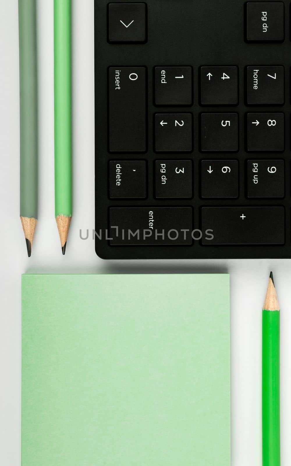 Colored paper with important message lying desk near keyboard. Main information written on notebook. School supplies. Multiple Assorted Collection Office Stationery. by nialowwa