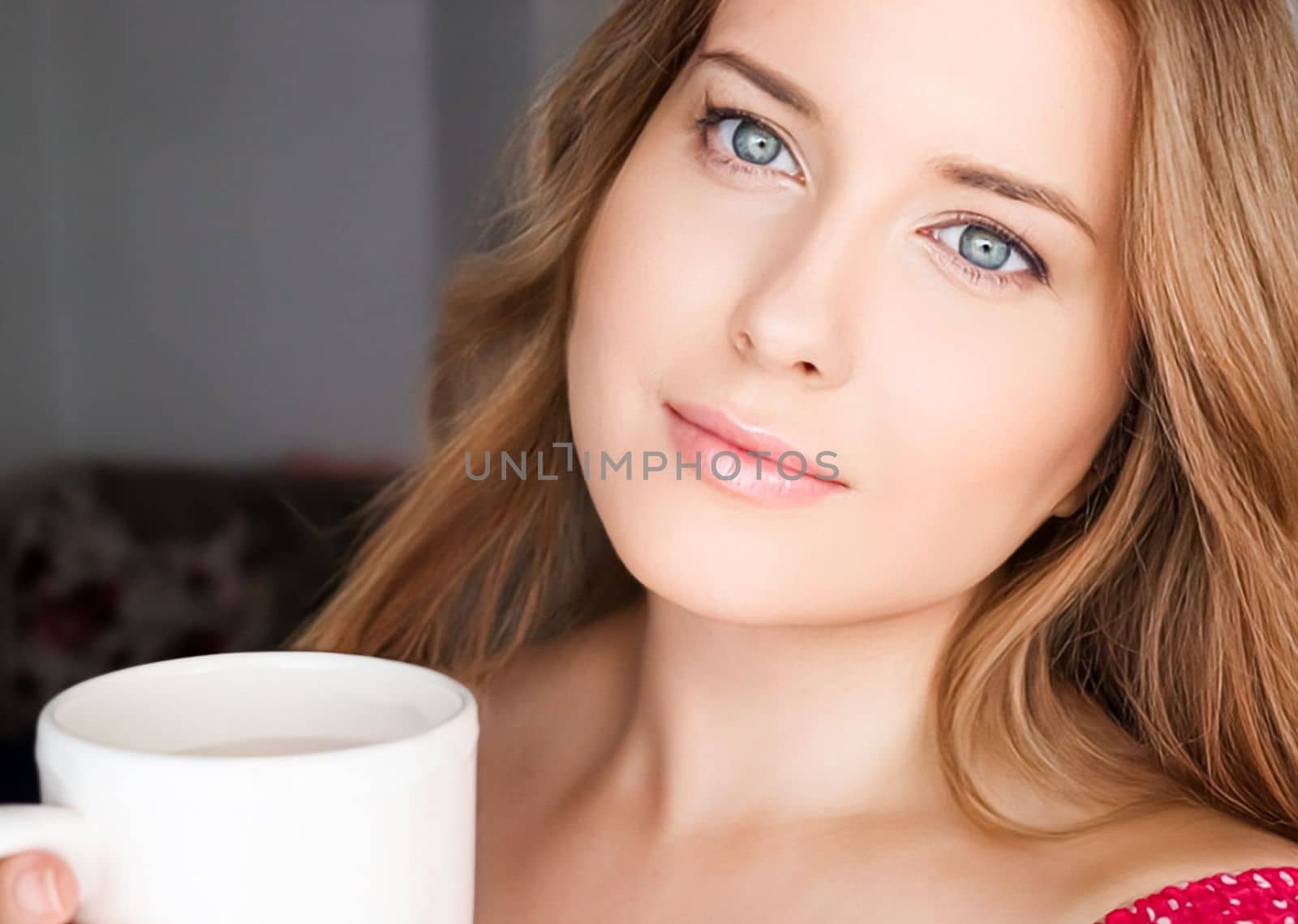 Beautiful woman having a cup of tea in the morning at home.