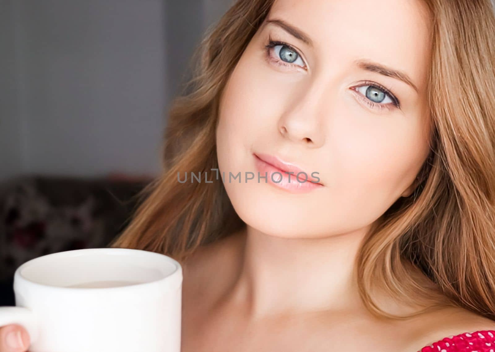 Beautiful woman having a cup of tea in the morning at home by Anneleven