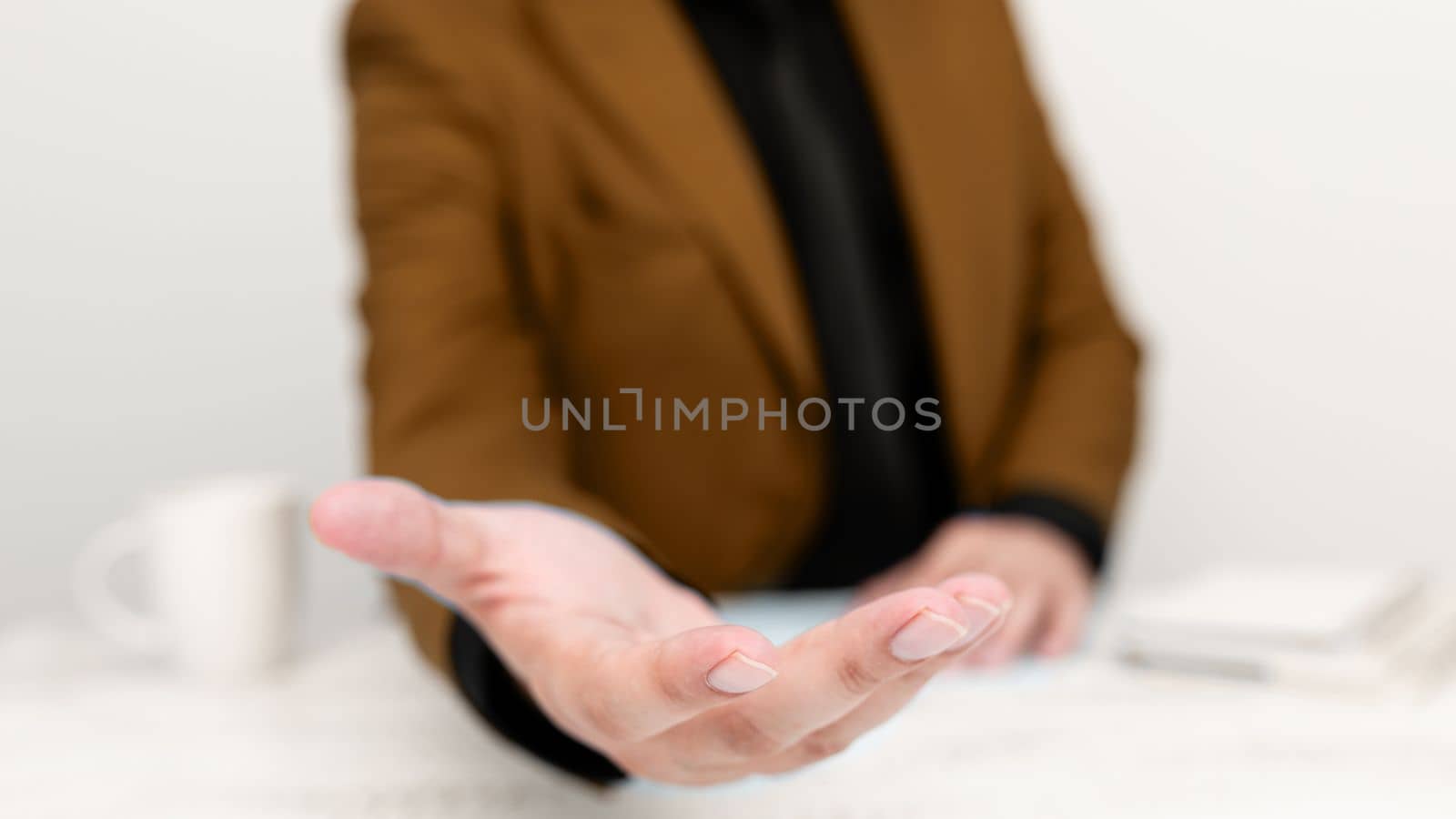 Businessman in Brown jacket Holding Important Message In One Hand. Man In Suit Showing New Crutial Idea In Palm. Executive Presenting Updated Critical Information. by nialowwa