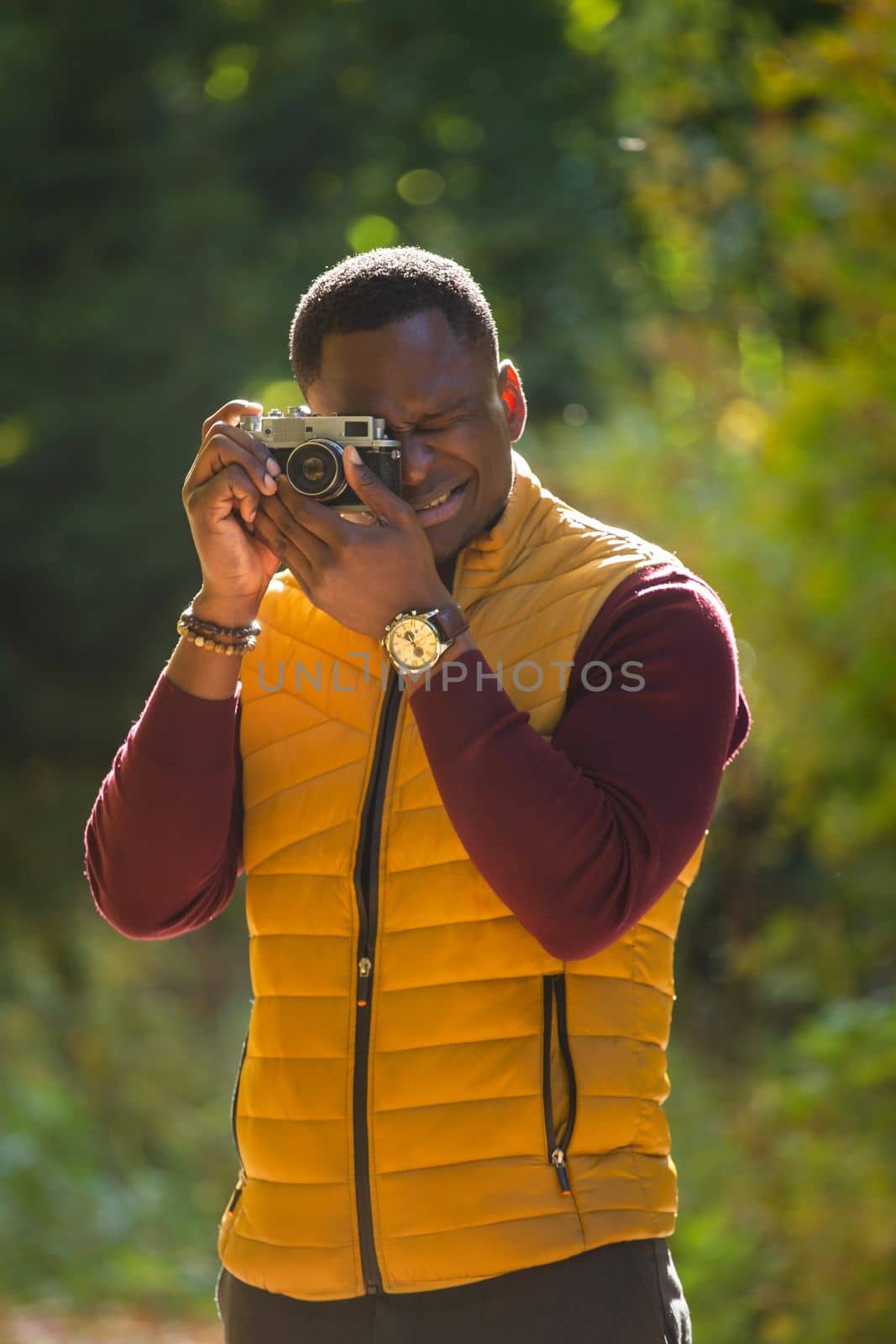 African american guy photographer taking picture with vintage camera on city green park - leisure activity, diversity and hobby concept by Satura86
