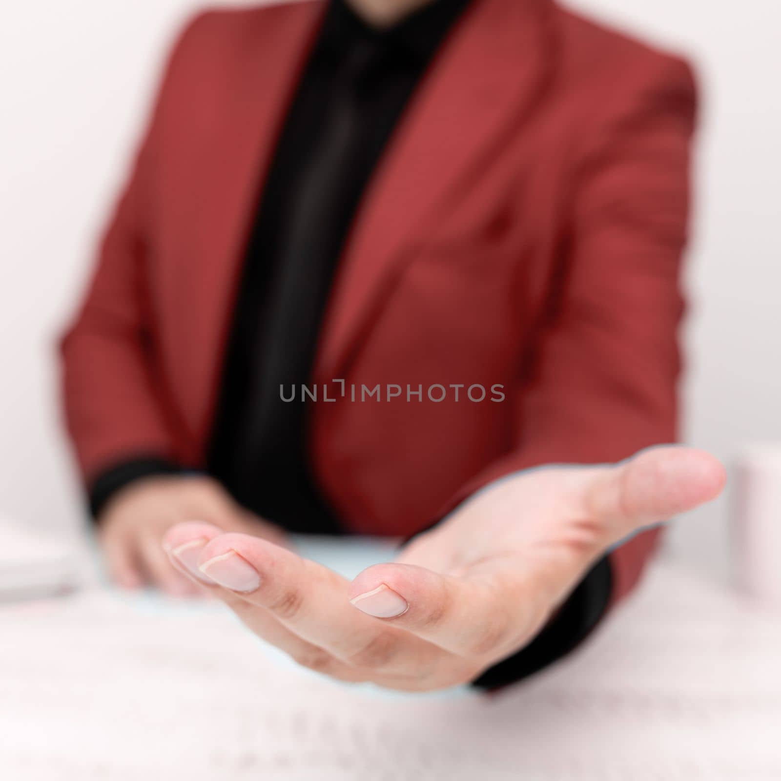 Businessman in Red jacket Holding Important Message In One Hand. Man In Suit Showing New Crutial Idea In Palm. Executive Presenting Updated Critical Information. by nialowwa