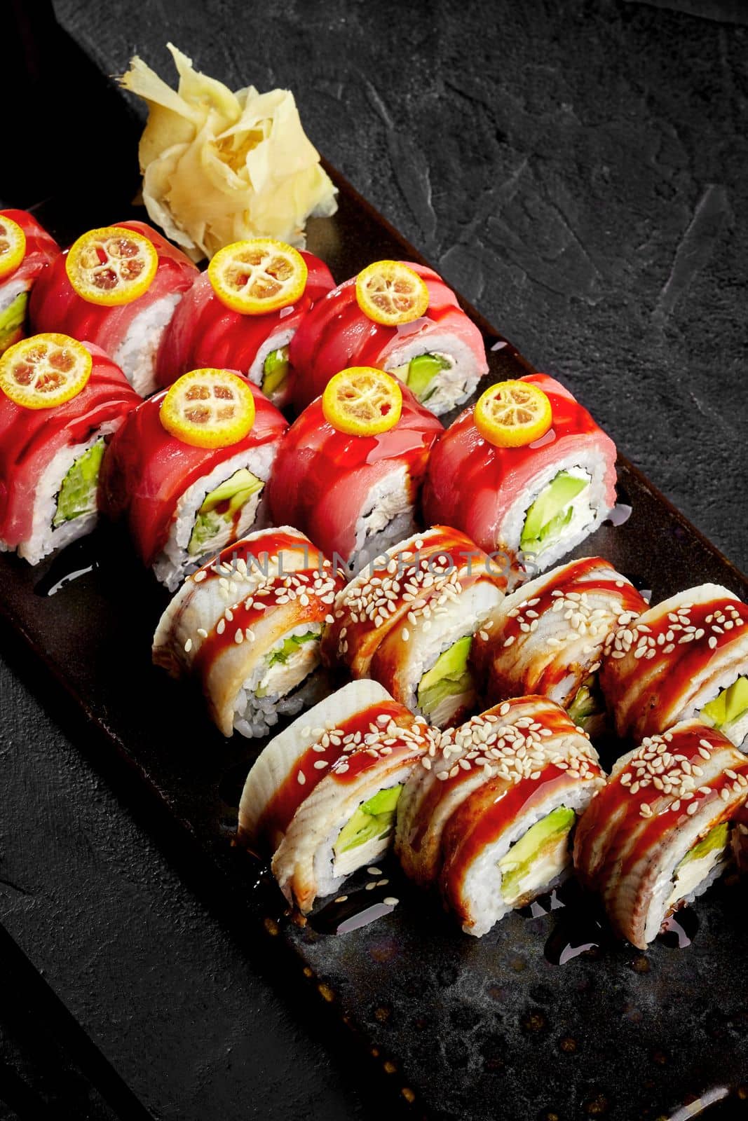 Sushi rolls with eel, tuna, cream cheese, avocado, cucumber, unagi sauce by nazarovsergey